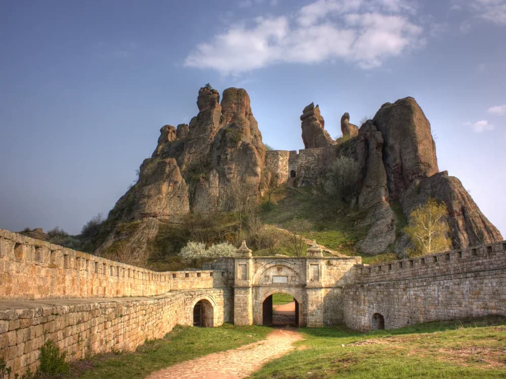 Belogradchik Fortress walls weaving between giant red sandstone rock formations in Bulgaria