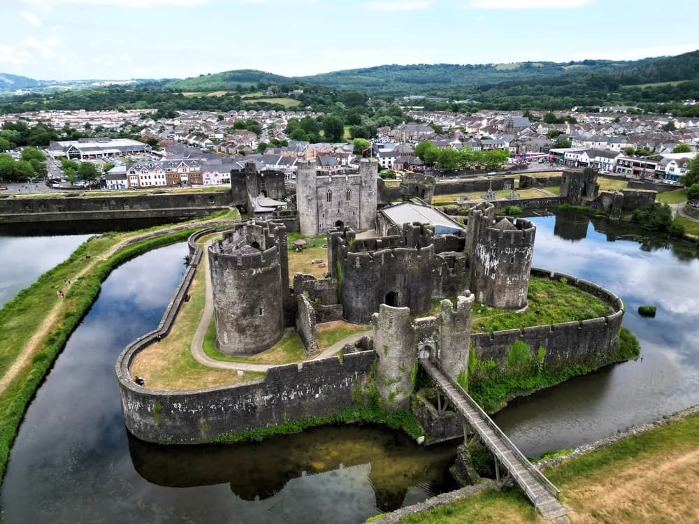 Caerphilly Castle reflected in its artificial lake with the famous leaning tower visible, South Wales