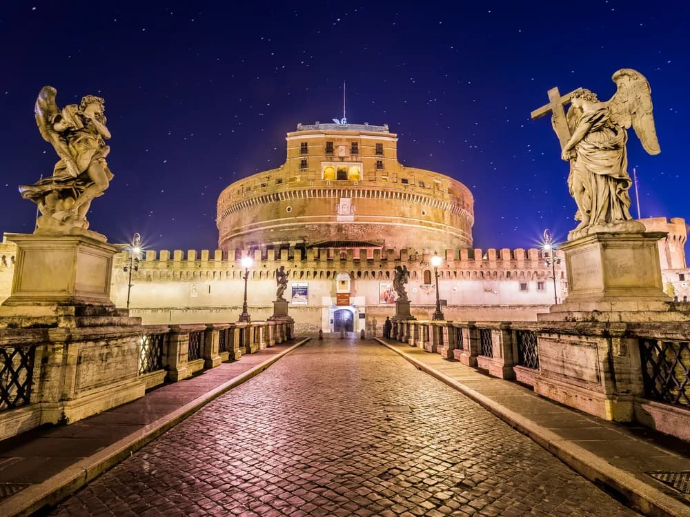 Castel Sant'Angelo reflected in the Tiber at dusk with the Ponte Sant'Angelo in the foreground