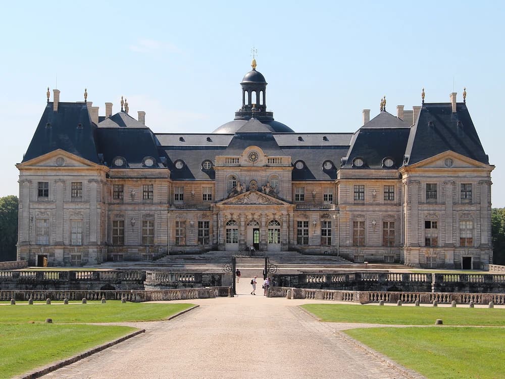 Château de Vaux-le-Vicomte reflected in the grand canal, with Le Nôtre's formal parterres stretching from the château steps to the horizon in Île-de-France