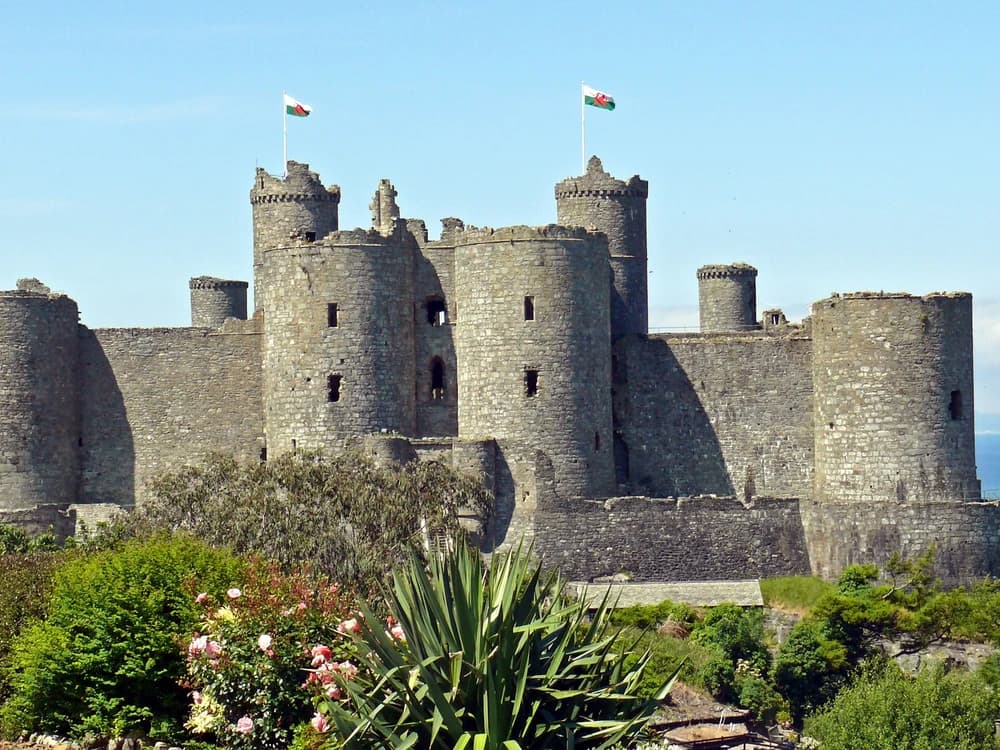 Harlech Castle's massive twin-towered gatehouse on its cliff above Cardigan Bay and the mountains of Snowdonia, Wales