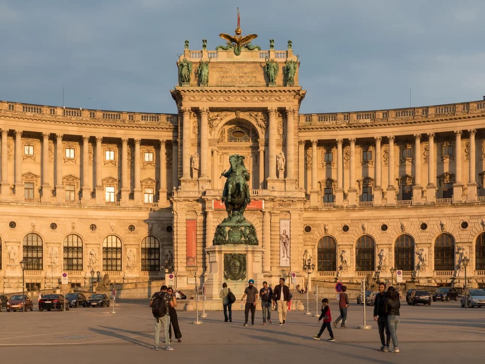 The Hofburg Palace's grand Michaelertor entrance facade in central Vienna, with its imperial dome and statuary against a clear sky