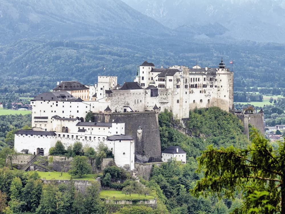Hohensalzburg Fortress rising above Salzburg's Baroque old town, with the Alps in the background
