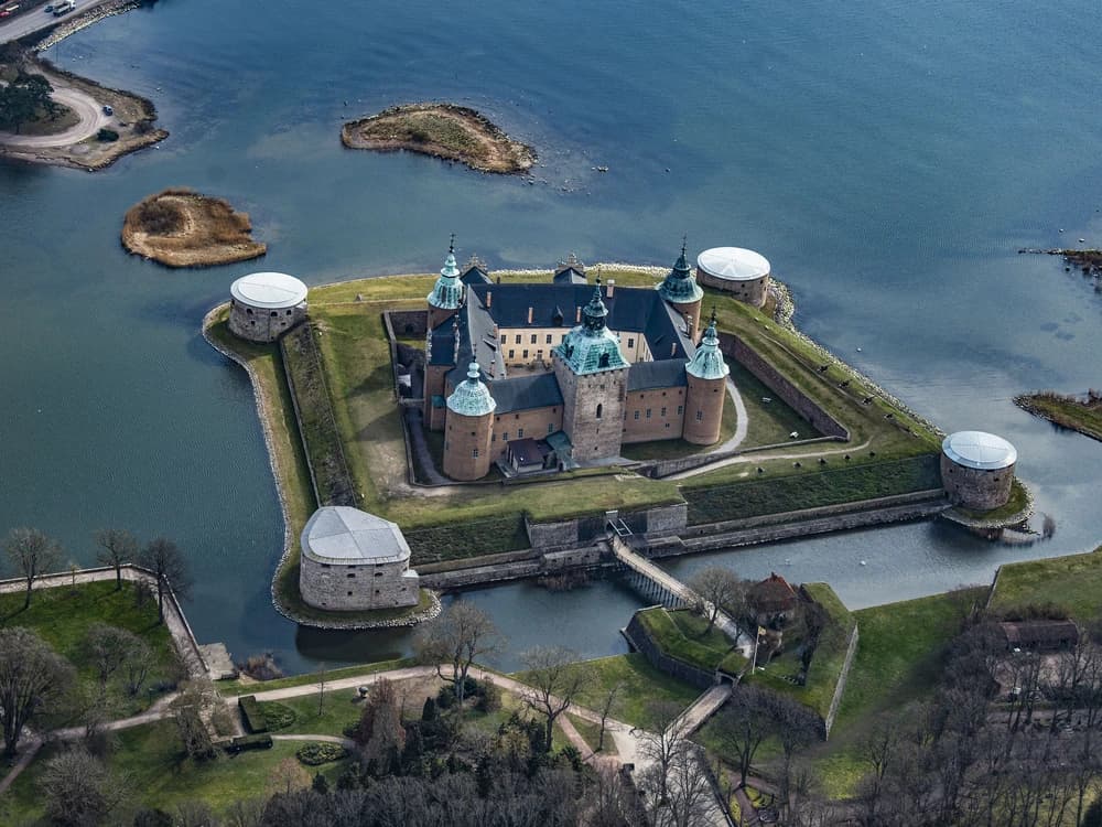 Kalmar Castle's round towers rising from the water at the edge of Kalmar Sound, Sweden