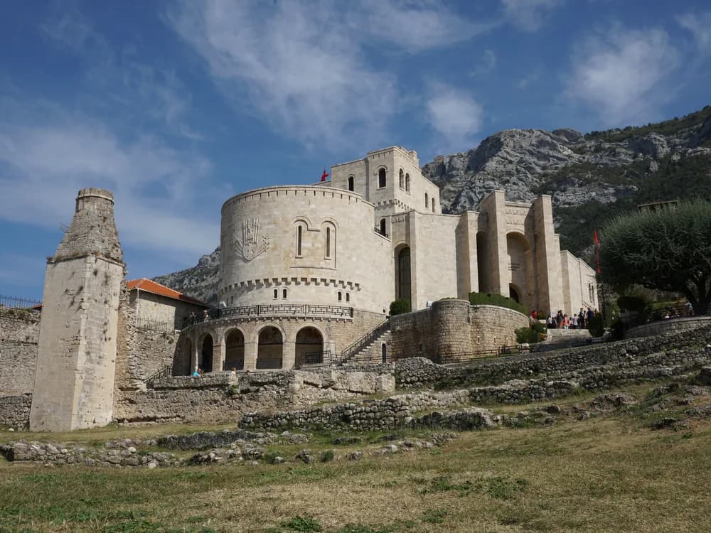 Krujë Castle ruins on the ridge above Krujë, Albania, with the coastal plain and Adriatic visible in the distance