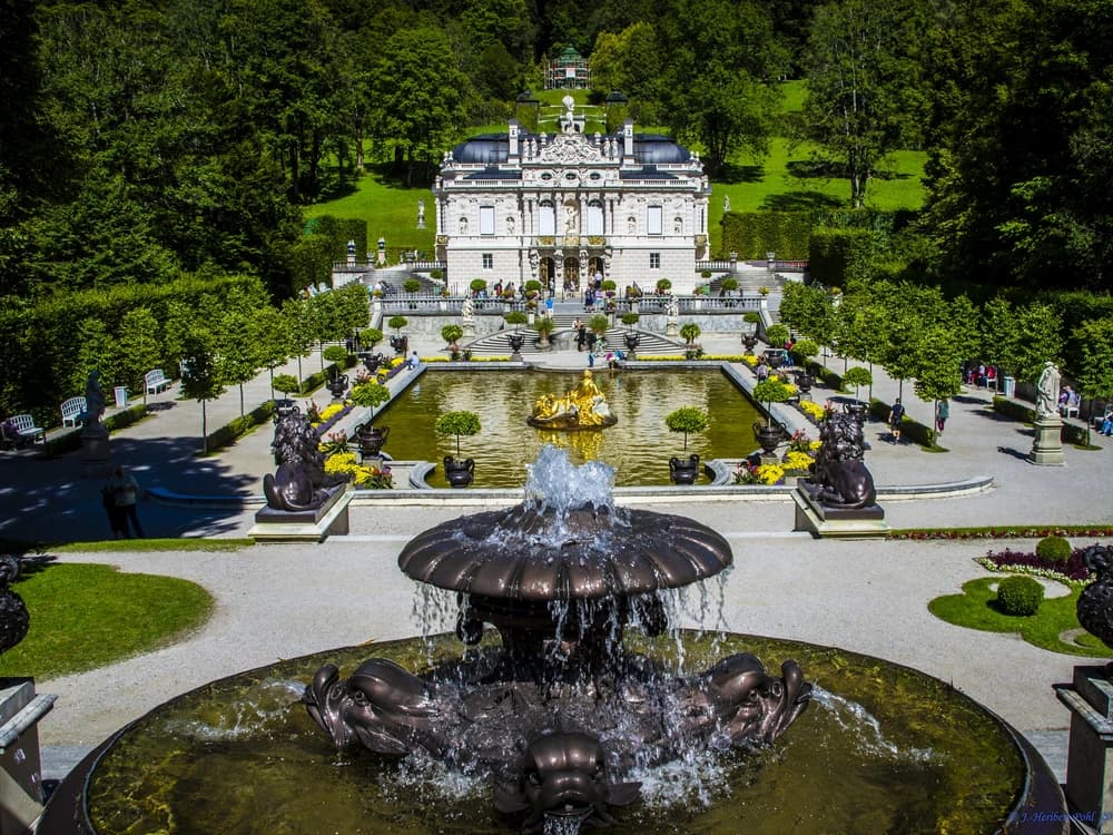 Linderhof Palace's Rococo Revival facade and formal fountain garden set in an Alpine valley near Oberammergau, Bavaria