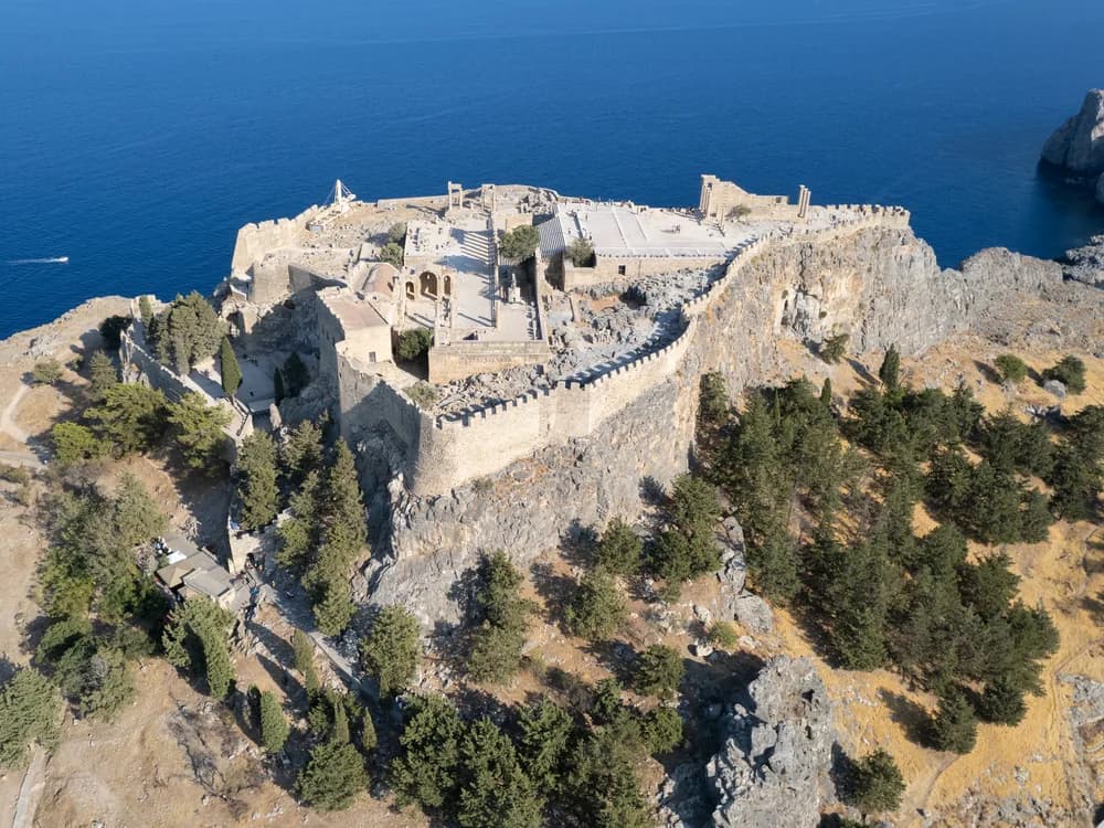 Lindos Acropolis and Knights' Castle above the white village and Aegean bay in Rhodes