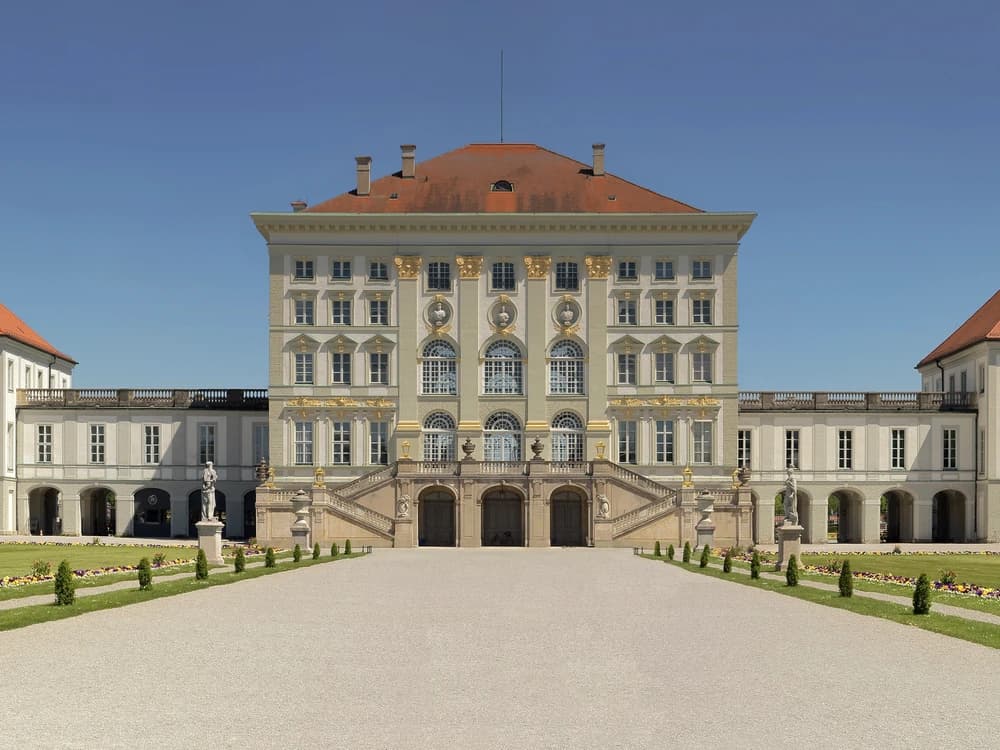 Nymphenburg Palace's wide Baroque facade reflected in its formal canal, Munich, Bavaria
