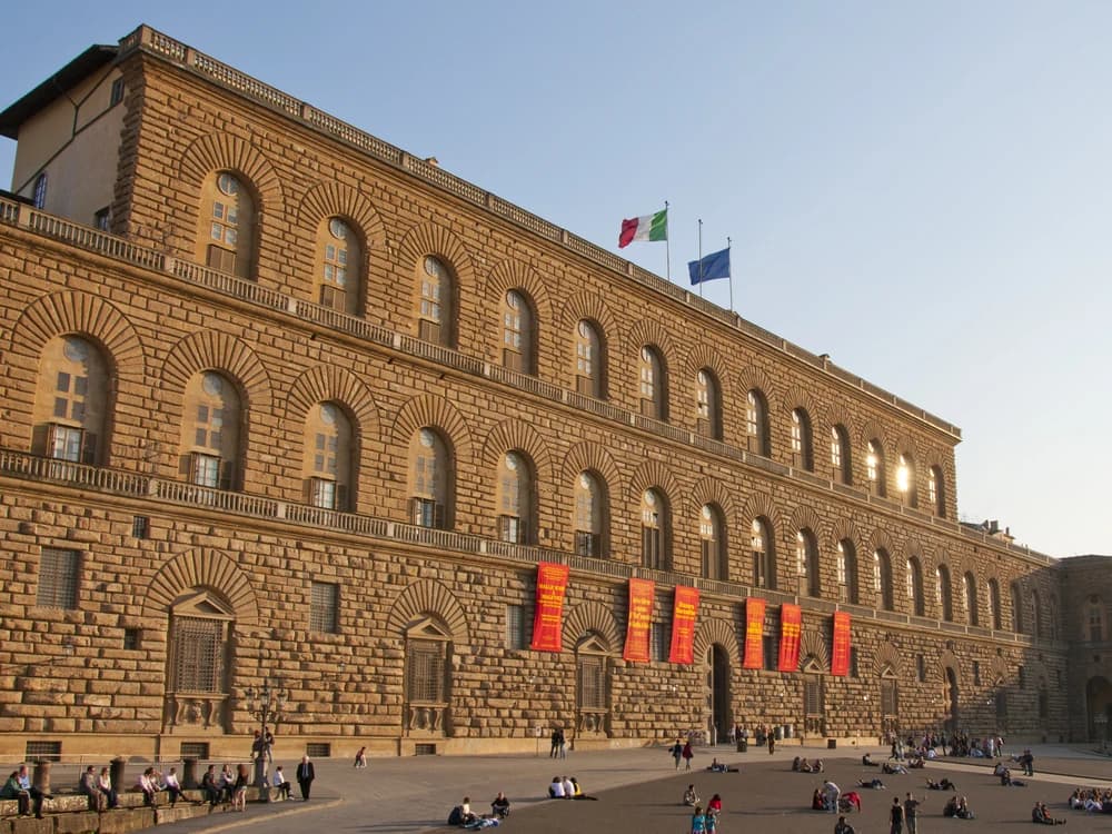 Palazzo Pitti's rusticated Renaissance facade in Florence's Oltrarno district, seen across Piazza de' Pitti