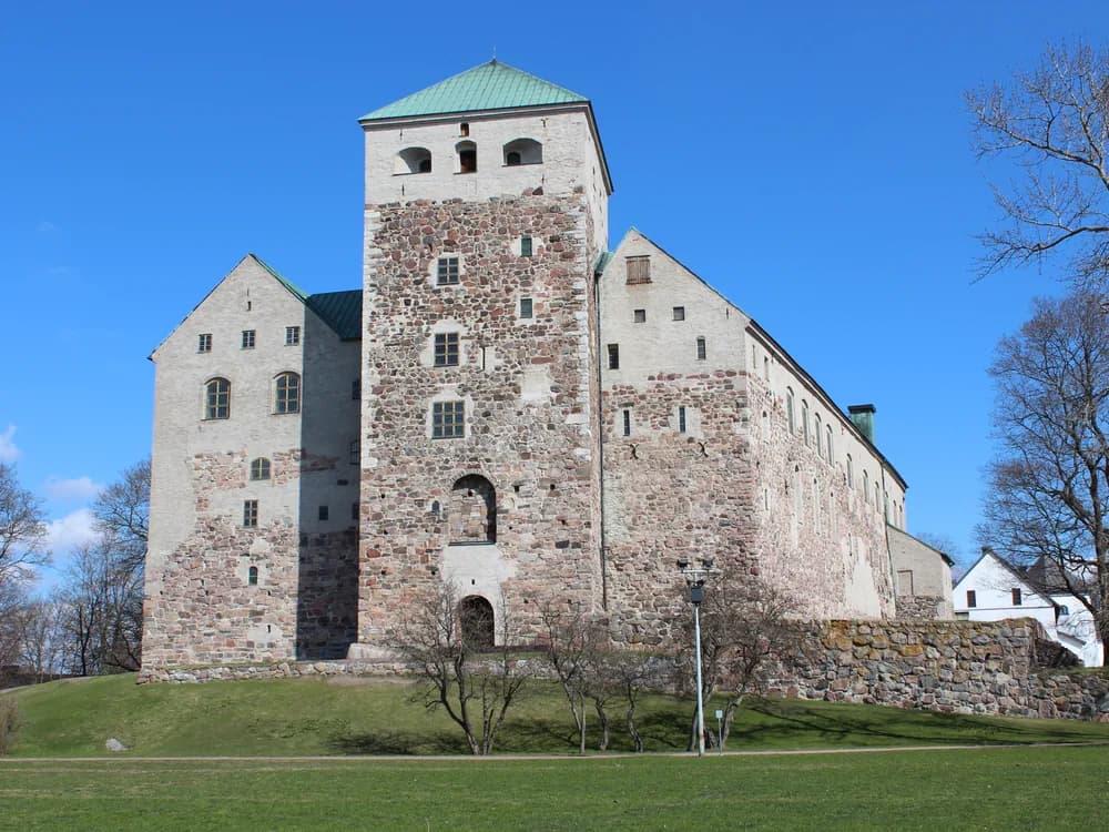 Turku Castle medieval towers at the mouth of the Aura River with the Baltic sea behind, Finland