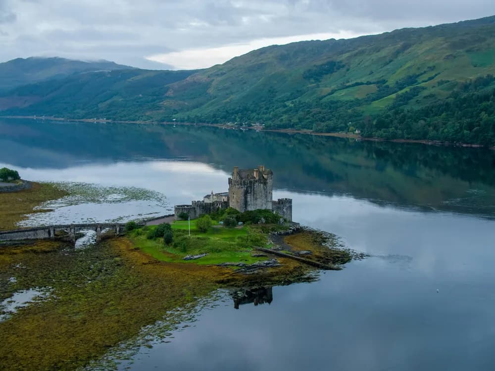 Eilean Donan Castle reflected in the still waters of Loch Duich at dawn
