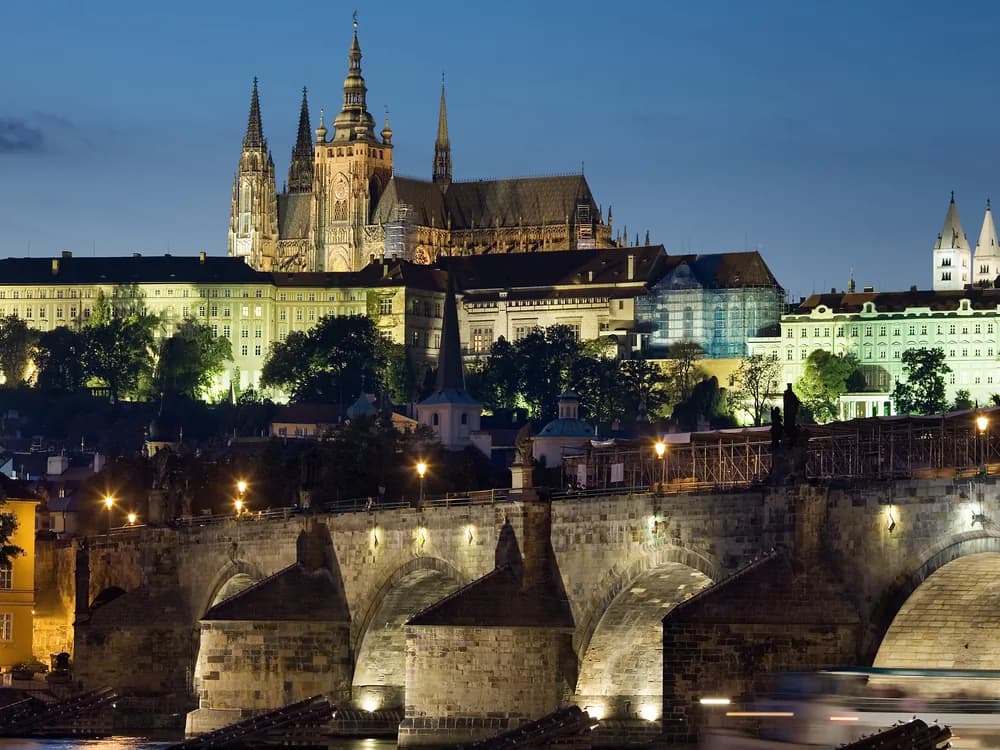 Prague Castle and St Vitus Cathedral rising above the Vltava river at dusk
