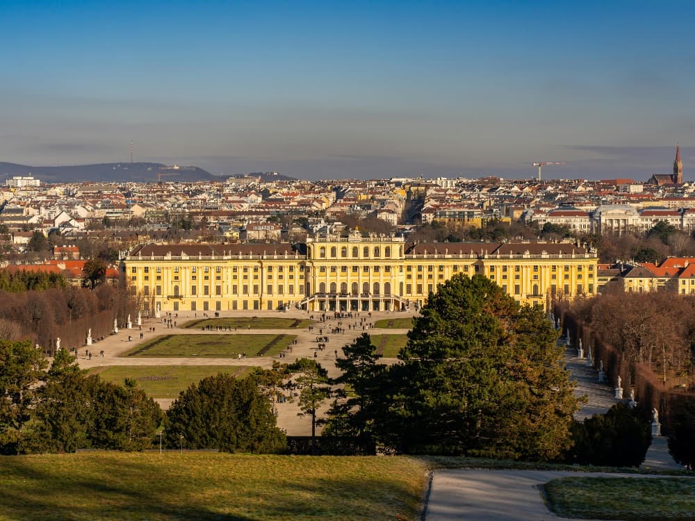 Schönbrunn Palace baroque facade with formal gardens and the Gloriette in the background
