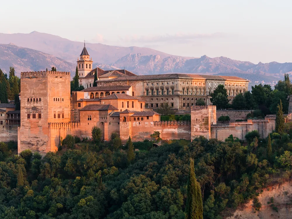 The Court of the Lions in the Nasrid Palaces of the Alhambra, Granada, with its famous 12-lion marble fountain