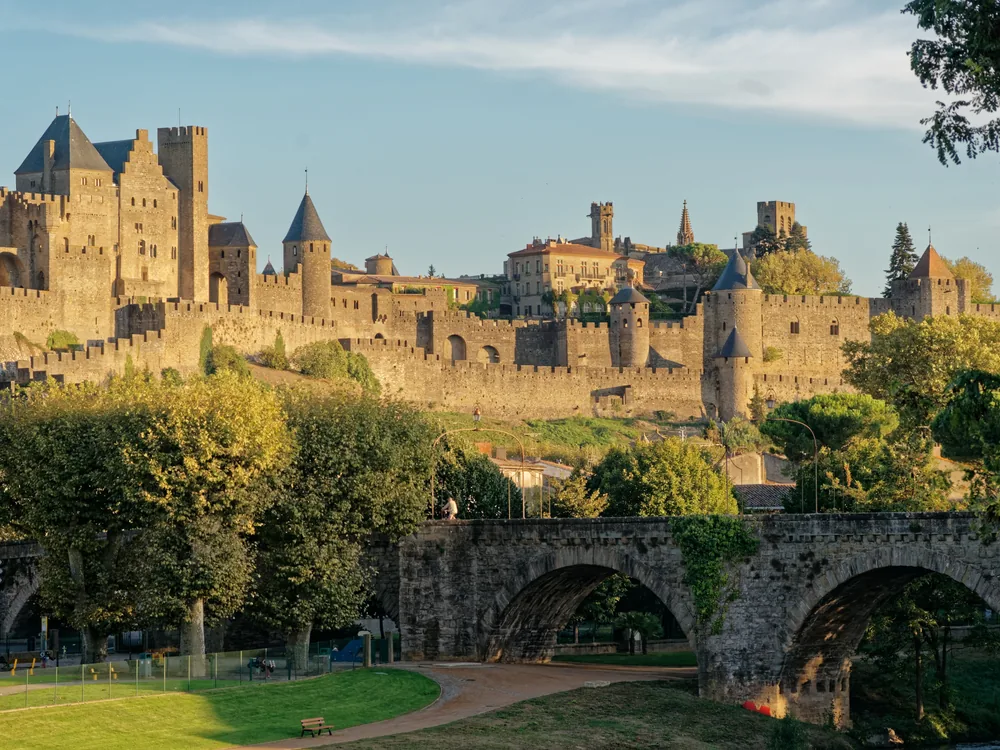 Carcassonne's double ring of towers and ramparts rising above the Languedoc plain at sunset